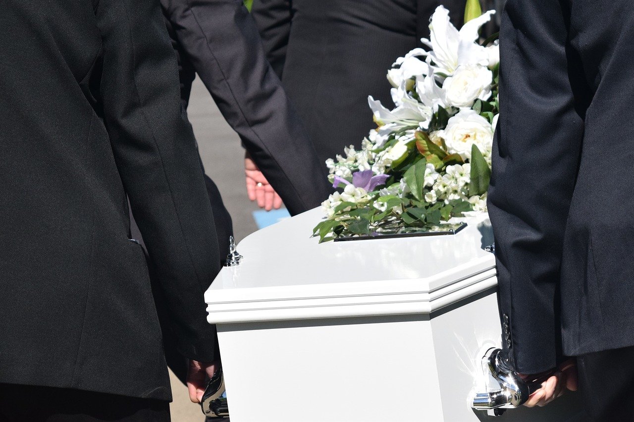 white casket at funeral