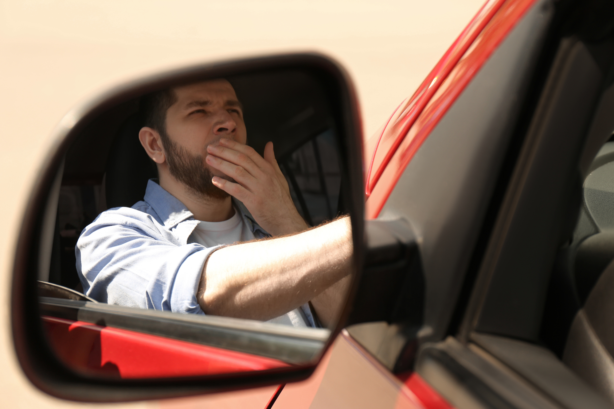 driver yawning in mirror